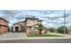 Charming two-story home boasts a well-manicured lawn, appealing desert landscaping, and an attached two-car garage at 15342 W Tasha Dr, Surprise, AZ 85374