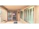 Covered outdoor patio with security door, exterior lantern, and windows with white shutters at 15342 W Tasha Dr, Surprise, AZ 85374