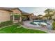 Beautiful backyard with pool, desert landscaping, patio, and outdoor kitchen/bar area at 15430 W Sells Dr, Goodyear, AZ 85395