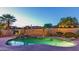 Inviting backyard oasis with a sparkling pool and relaxing waterfall, perfect for outdoor entertaining and leisure at 15430 W Sells Dr, Goodyear, AZ 85395