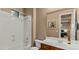Bright bathroom with a tub, toilet, white countertops, dark wood vanity and neutral walls at 15430 W Sells Dr, Goodyear, AZ 85395