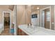 Bathroom with a long mirror, white countertop, wooden vanity, and tile floors at 15430 W Sells Dr, Goodyear, AZ 85395
