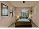 Comfortable bedroom with a ceiling fan, neutral walls, bedside tables, and a cozy bed set against carpeted floors at 15430 W Sells Dr, Goodyear, AZ 85395