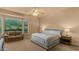 Relaxing bedroom with a ceiling fan, lots of natural light, a cozy couch, and a plush bed at 15430 W Sells Dr, Goodyear, AZ 85395