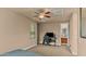 Functional bedroom with a ceiling fan, neutral walls, and a desk for work or gaming set against carpeted floors at 15430 W Sells Dr, Goodyear, AZ 85395