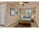 Serene bedroom with a ceiling fan, neutral walls, and a cozy bed set against carpeted floors at 15430 W Sells Dr, Goodyear, AZ 85395