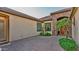 Private courtyard with brick pavers, desert plants, and elegant entrance at 15430 W Sells Dr, Goodyear, AZ 85395