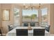 Elegant dining area featuring a table for six, chandelier lighting and backyard view at 15430 W Sells Dr, Goodyear, AZ 85395