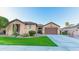 Charming single-story home with well-maintained landscaping and a two-car garage at 15430 W Sells Dr, Goodyear, AZ 85395