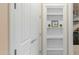Hallway with a built-in bookshelf at 15430 W Sells Dr, Goodyear, AZ 85395