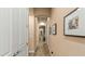 Hallway with neutral paint, tile flooring, and white trim at 15430 W Sells Dr, Goodyear, AZ 85395