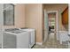 Functional laundry room with modern appliances and ample storage cabinets at 15430 W Sells Dr, Goodyear, AZ 85395
