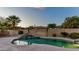 Side yard with low-maintenance gravel, desert landscaping, and a partial view of the neighbor's roof at 15430 W Sells Dr, Goodyear, AZ 85395