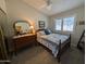 Inviting bedroom featuring a vintage dresser, comfortable bed with blue accents, and a ceiling fan, offering comfort at 170 E Guadalupe Rd # 154, Gilbert, AZ 85234