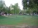Well-maintained community green space with mature trees and manicured lawns at 170 E Guadalupe Rd # 154, Gilbert, AZ 85234