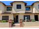 Inviting exterior showcasing a townhouse with a well-manicured lawn and brick accents at 170 E Guadalupe Rd # 154, Gilbert, AZ 85234