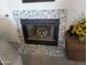 Close up on a tiled fireplace with marble hexagon tiles next to a seating area at 170 E Guadalupe Rd # 154, Gilbert, AZ 85234