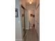 Hallway with closet and an open door to the bathroom featuring neutral tones and contemporary design elements at 170 E Guadalupe Rd # 154, Gilbert, AZ 85234