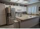 Bright kitchen featuring white cabinets, stainless steel appliances, and skylight, exuding a clean and modern feel at 170 E Guadalupe Rd # 154, Gilbert, AZ 85234