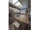 Bright kitchen featuring white cabinets, stainless steel appliances, and skylight, exuding a clean and modern feel at 170 E Guadalupe Rd # 154, Gilbert, AZ 85234