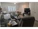 Spacious living room featuring grey sofas, laminate floors, and bright natural light at 170 E Guadalupe Rd # 154, Gilbert, AZ 85234
