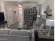 Comfortable living room featuring plush sofas, laminate floors, and a display shelf at 170 E Guadalupe Rd # 154, Gilbert, AZ 85234