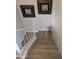 Upstairs staircase with laminate floors and white railing at 170 E Guadalupe Rd # 154, Gilbert, AZ 85234