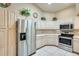 Bright kitchen featuring modern stainless steel appliances, ample cabinet space, and tile floor at 17094 N Silver Path, Surprise, AZ 85374