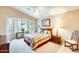 Cozy main bedroom featuring neutral colors, a large bay window, and vaulted ceilings at 17094 N Silver Path, Surprise, AZ 85374