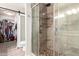 Updated bathroom boasts stone pebble floor shower with glass doors at 19084 N Toledo Ave, Maricopa, AZ 85138