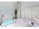Bright bedroom with hardwood floors, ceiling fan, dresser, and closet at 19084 N Toledo Ave, Maricopa, AZ 85138