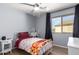 Well lit bedroom with hardwood floors, ceiling fan and window at 19084 N Toledo Ave, Maricopa, AZ 85138