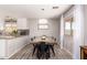 Inviting dining room featuring stylish light fixture and modern finishes, adjacent to the kitchen at 19084 N Toledo Ave, Maricopa, AZ 85138
