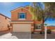 Two-story home showcasing a well-maintained yard, 2-car garage, and desert landscaping at 19084 N Toledo Ave, Maricopa, AZ 85138