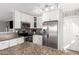 Open kitchen design featuring stainless appliances, white cabinetry and stylish countertops at 19084 N Toledo Ave, Maricopa, AZ 85138