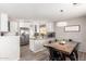 Updated kitchen boasting white cabinetry, stainless steel appliances, and a breakfast bar at 19084 N Toledo Ave, Maricopa, AZ 85138