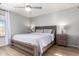 Spacious main bedroom with a ceiling fan, two lamps and wood flooring at 19084 N Toledo Ave, Maricopa, AZ 85138