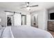 Main bedroom with barn doors, a walk-in closet and an ensuite bath at 19084 N Toledo Ave, Maricopa, AZ 85138
