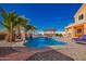 Incredible backyard pool features vibrant blue water, a small waterfall, and lounge chairs at 19084 N Toledo Ave, Maricopa, AZ 85138