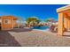 Incredible backyard pool features vibrant blue water, a small waterfall, with a shed at 19084 N Toledo Ave, Maricopa, AZ 85138