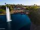 Scenic aerial view of a community pool and lake with lush trees and flowering shrubs at 19644 N Majestic Vista Ct, Surprise, AZ 85387