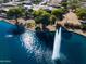 Aerial view of a waterfront homesite featuring lush trees and a water fountain in a pond at 19644 N Majestic Vista Ct, Surprise, AZ 85387