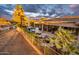 Large backyard with a pool, covered patio, and outdoor kitchen, enclosed by a decorative wrought iron fence at 19644 N Majestic Vista Ct, Surprise, AZ 85387
