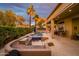 Expansive backyard with an outdoor kitchen, sparkling pool, and covered patio, ideal for relaxing and entertaining at 19644 N Majestic Vista Ct, Surprise, AZ 85387