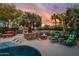 Beautiful outdoor space with an outdoor kitchen, fire pit, seating, and desert landscaping, creating a serene retreat at 19644 N Majestic Vista Ct, Surprise, AZ 85387
