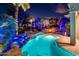 Backyard with a sparkling pool, stone waterfall, and desert landscaping, creating a private oasis at 19644 N Majestic Vista Ct, Surprise, AZ 85387