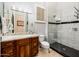 Updated bathroom featuring marble counters, glass shower enclosure, modern fixtures, and wood cabinets at 19644 N Majestic Vista Ct, Surprise, AZ 85387