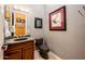 Stylish bathroom features granite counter, modern faucet, artwork on the wall, and a toilet at 19644 N Majestic Vista Ct, Surprise, AZ 85387