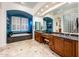 Bright bathroom with dual vanities, modern fixtures, and a luxurious soaking tub at 19644 N Majestic Vista Ct, Surprise, AZ 85387