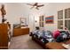 Comfortable bedroom with carpet, shutters, a ceiling fan, and plenty of natural light at 19644 N Majestic Vista Ct, Surprise, AZ 85387